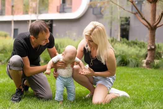 Happy young family spending time together outside in green nature