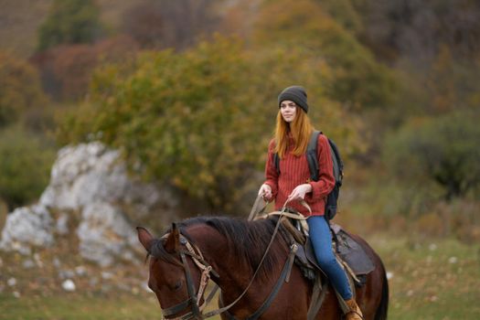 woman hiker riding a horse on nature travel. High quality photo