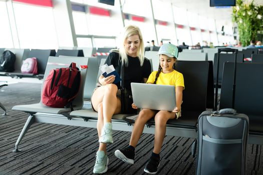 Mother and little daughter at airport terminal.