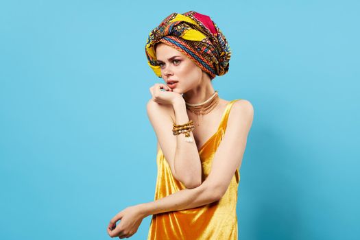 pretty woman in multicolored turban attractive look Jewelry smile isolated background. High quality photo