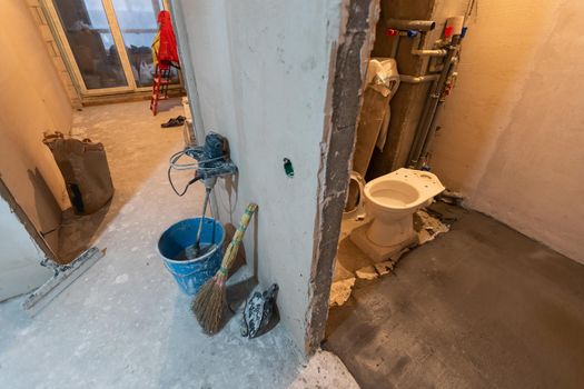 Toilet bowl in the bathroom. Repair. Sanitary ceramics. Plumbing. Water pipes. Plastic faucet. Floor standing toilet