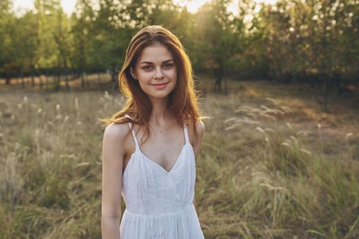 pretty woman in white dress in the field nature trees freedom. High quality photo