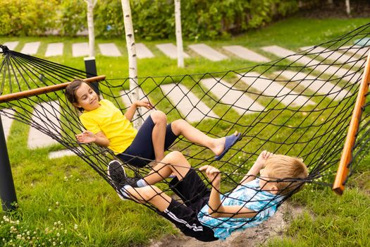 children in a hammock. Happy family holiday