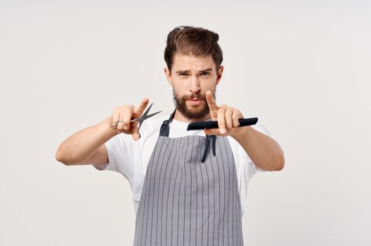 barbershop man gray apron comb scissors professional hairdresser cropped view. High quality photo