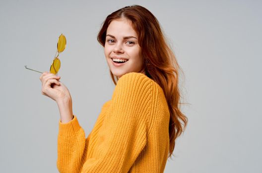 pretty woman in yellow glasses posing fun lifestyle light background. High quality photo