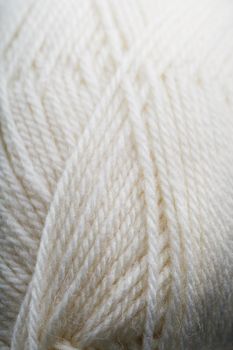 White threads of natural wool close-up in full screen. Macro