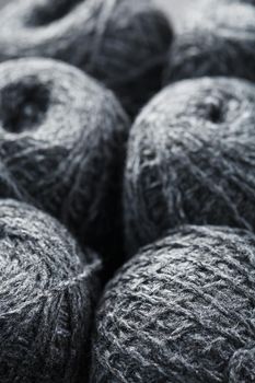 Gray yarn made of natural wool in balls of thread. Close-up
