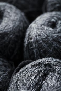 Gray yarn made of natural wool in balls of thread. Close-up