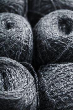 Gray yarn made of natural wool in balls of thread. Close-up