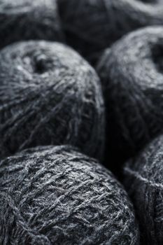 Gray yarn made of natural wool in balls of thread. Close-up