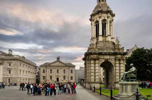 View of the campus of Trinity College in Dublin, Ireland's oldest university, with a group of tourists visiting it.