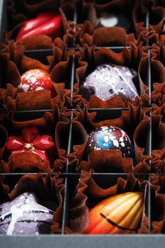 Handmade chocolates in a box. Production of confectionery products. colorful candies, culinary art.