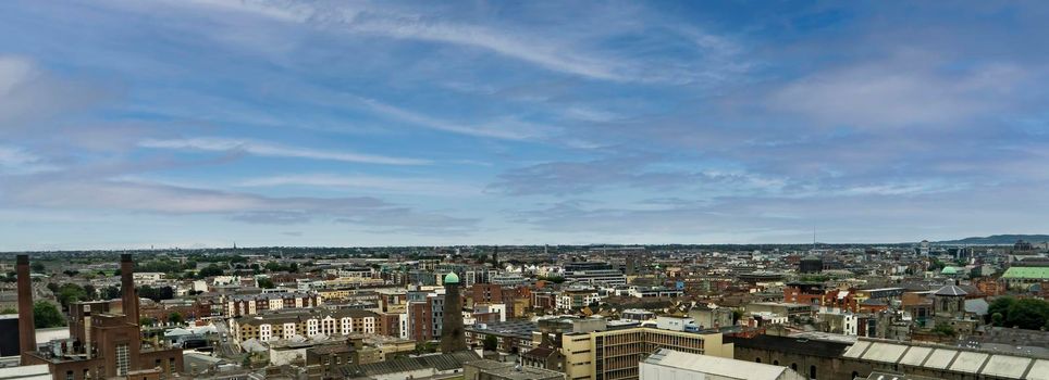 Panoramic aerial view of the city of Dublin in Ireland with blue sky and light clouds.