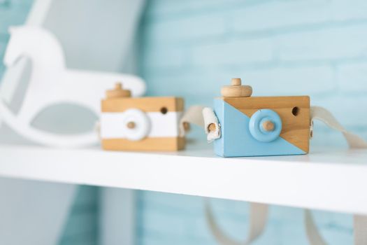 Toy wooden camera for children or decoration standing on shelf Creative childhood concept