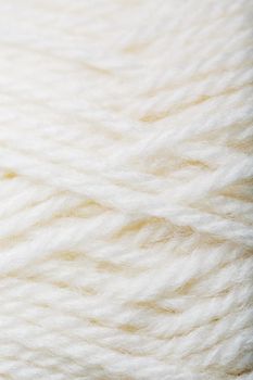 White wool yarn close-up in full screen. Macro