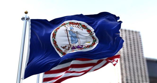 the flag of the US state of Virginia waving in the wind with the American flag blurred in the background. Virginia was admitted to the Union on June 25, 1788 as 10th state