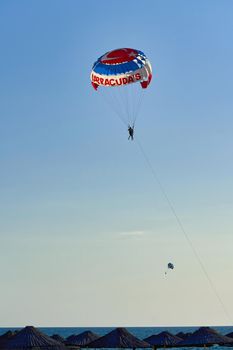 Parachute over the sea, resort water activities. Extreme vacation by the sea