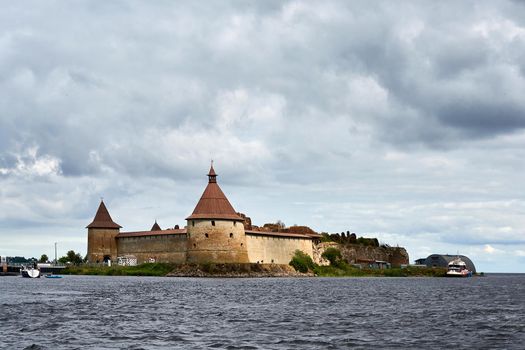 Natural landscape with a view of the old fortress by the lake. Sunny spring day