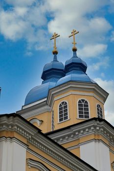 Fragment of the bell tower of a Christian church with a blue roof. Church bell tower against the sky