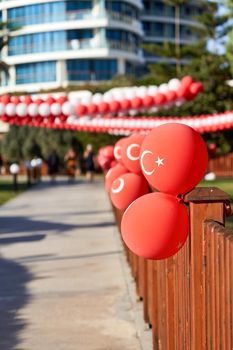 Red balloons with the emblem of the flag of Turkey decorate the street. Turkey Independence Day
