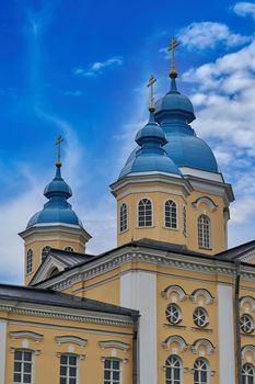 Fragment of the bell tower of a Christian church with a blue roof. Church bell tower against the sky