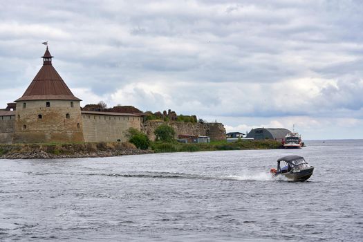 Natural landscape with a view of the old fortress by the lake. Sunny spring day