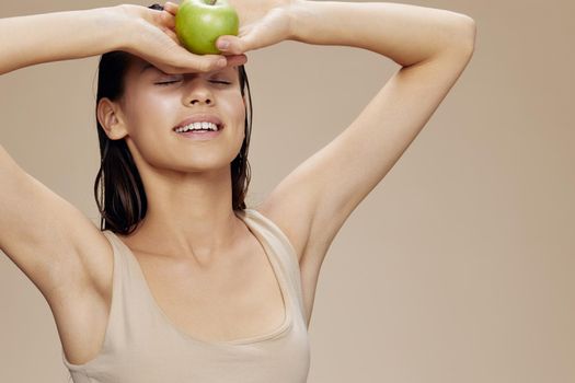 portrait woman green apple near face health isolated background. High quality photo