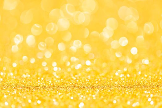 sparkles of yellow glitter abstract background. Copy space.