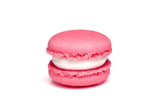 Pink strawberry macaroon isolated on white background. French cookie. Raspberry purple cake in a front view. Bakery concept with blank space