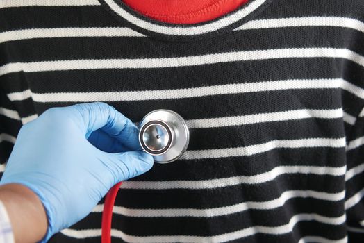 Doctor using a stethoscope checking body.