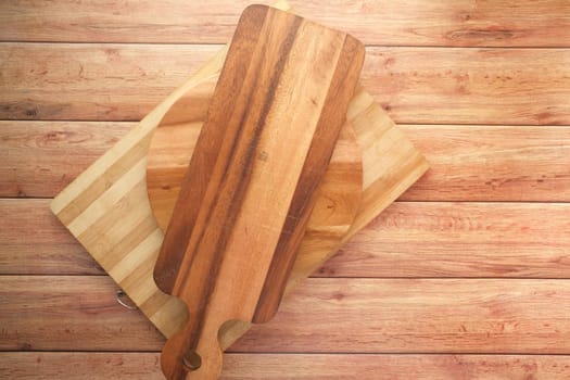 wooden chopping board on black background top down.