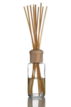 Home fragrance diffuser with wooden sticks on white background.