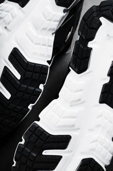 The black and white sole of trendy sports sneakers is a close-up in full screen. Shoe cushioning technology