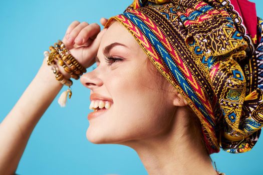 beautiful woman ethnicity multicolored headscarf makeup glamor isolated background. High quality photo