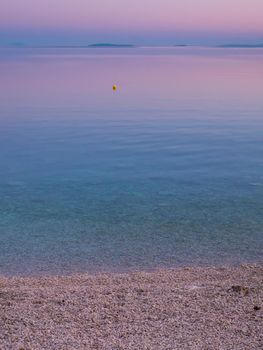 Beach and sea view on island Vir, Croatia early in the morning. Beautiful purple and pink sky and Adriatic sea.