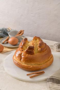 Fogaça on kitchen countertop with eggs and cinammon sticks. Traditional cake from Santa Maria da Feira, Portugal.