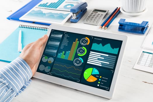 close-up, male hands with tablet. Businessman working at the table in office