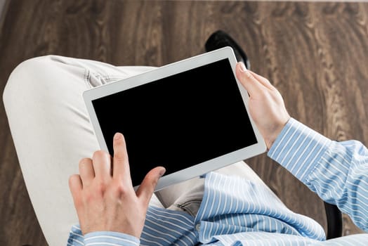 close-up of men's hands with a computer tablet. Businessman works in the office