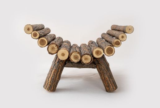 Wooden log bed for newborn baby studio photoshoot. Rural couch furniture for infant child photo session