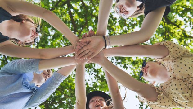 Group of female hands together in the park