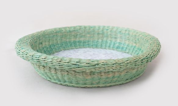 Designed craft wicker basin basket light blue color material isolated on white background. Handmade decorative craft eco form