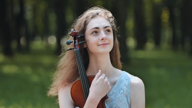Portrait of a young girl with her violin