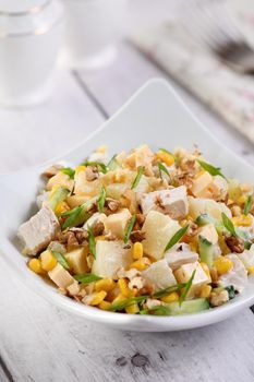 Chicken salad with pineapple, corn and cucumber dressed with Greek yogurt, crushed nuts and cheese.