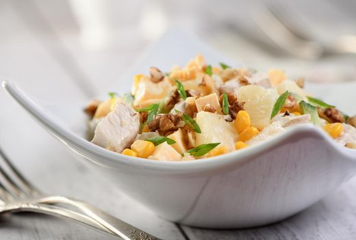 Chicken salad with pineapple, corn and cucumber dressed with Greek yogurt, crushed nuts and cheese.
