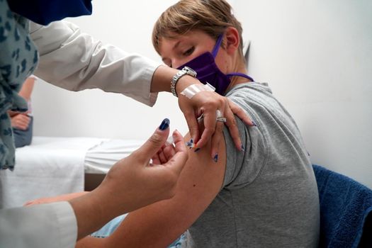 Young teenage boy getting his covid vaccination