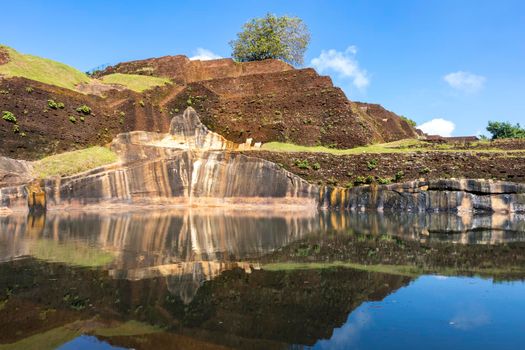 Sri Lanka. Sigiriya Dambulla. The most famous attraction - Lion Rock. View of the pyramid-shaped palace and the pool at the top of the mountain. High quality photo