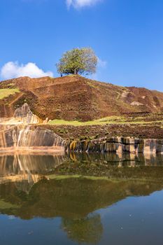 Sri Lanka. Sigiriya Dambulla. The most famous attraction - Lion Rock. View of the pyramid-shaped palace and the pool at the top of the mountain. High quality photo