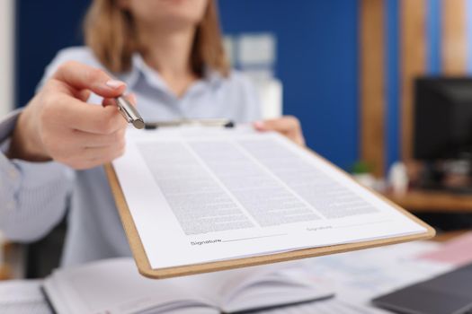 Close-up of businesswoman give silver pen to client to put signature on contract paper. Prepared business document for client. Business, agreement concept