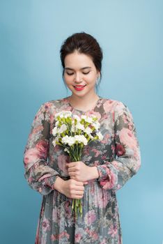 Joyful asia girl playing with her romantic dress 