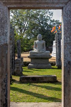 Sri Lanka. Anuradhapura. Thuparamaya Stupa is the earliest Dagoba to be constructed in the island. A statue of a sitting Buddha. High quality photo